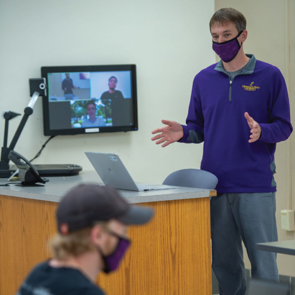 At Minnesota State University, Mankato, classrooms equipped with monitors, microphones, and speakers allow students to participate both in person and remotely.